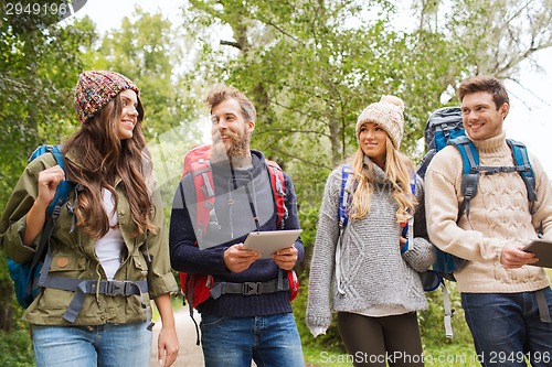 Image of group of friends with backpacks and tablet pc