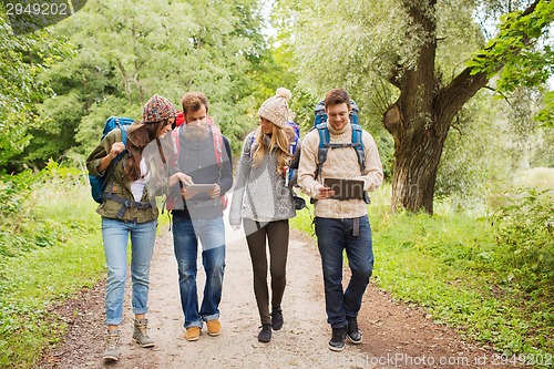 Image of group of friends with backpacks and tablet pc