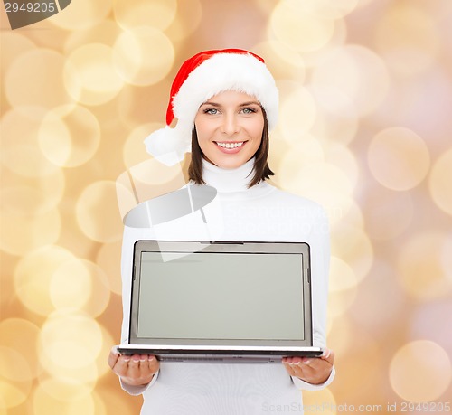 Image of woman in santa helper hat with laptop computer