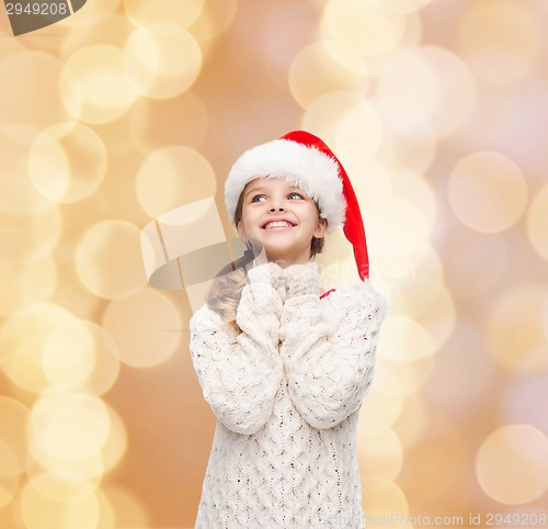 Image of dreaming girl in santa helper hat