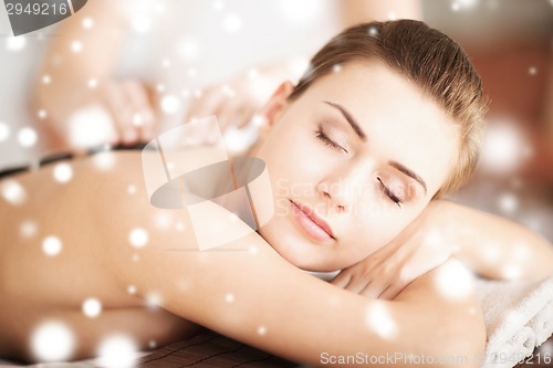 Image of woman in spa with hot stones