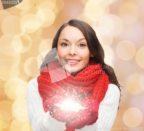 Image of smiling woman in winter clothes with snowflake