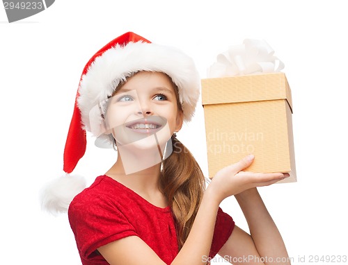 Image of smiling girl in santa helper hat with gift box