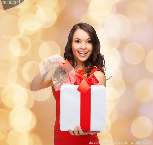 Image of smiling woman in red dress with gift boxes