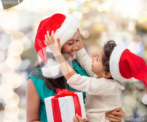 Image of happy mother and child girl with gift box