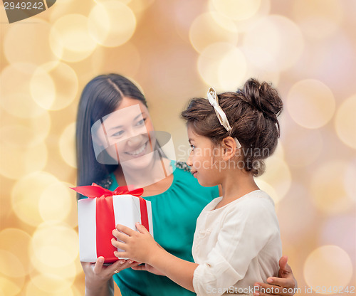 Image of happy mother and child girl with gift box