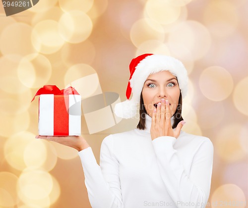 Image of smiling woman in santa helper hat with gift box