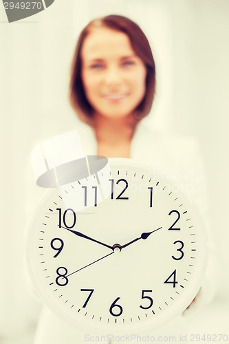 Image of attractive businesswoman with white clock