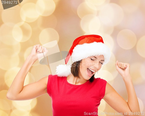 Image of smiling woman in santa helper hat