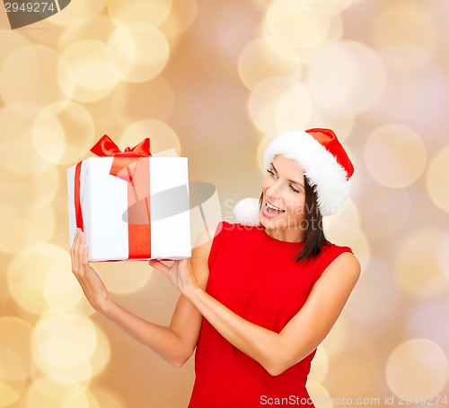 Image of smiling woman in red dress with gift box