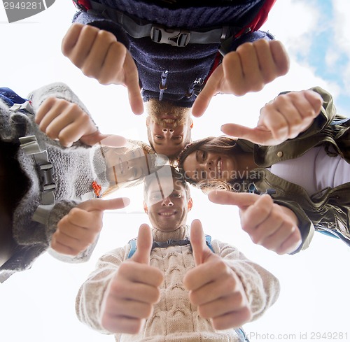 Image of group of smiling friends with backpacks hiking