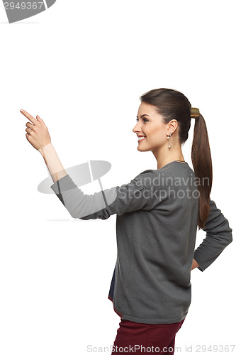 Image of Side view of woman pointing at copy space