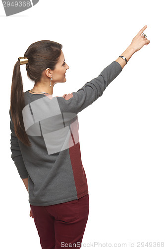 Image of Back view of woman pointing at copy space