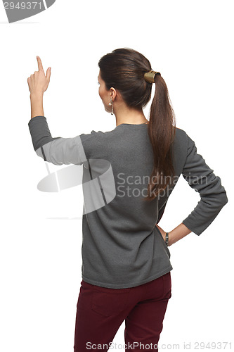 Image of Back view of woman pointing at copy space