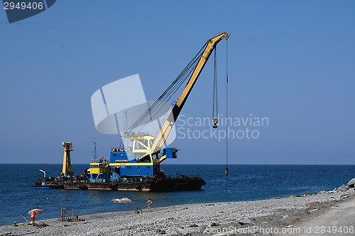 Image of The floating crane on the seacoast