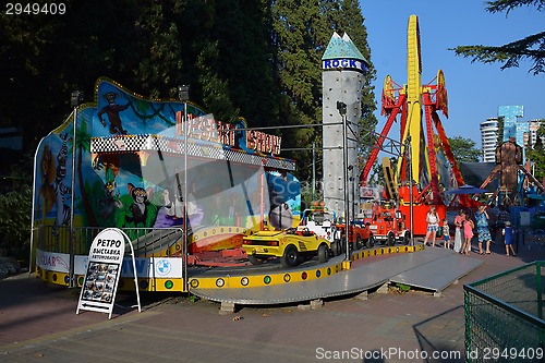 Image of Attractions and roundabouts in Riviera park with visitors