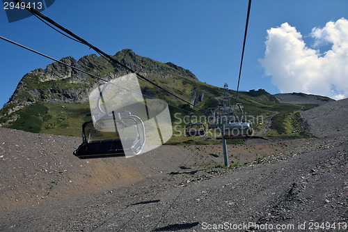 Image of Empty chairlifts moving in the mountains