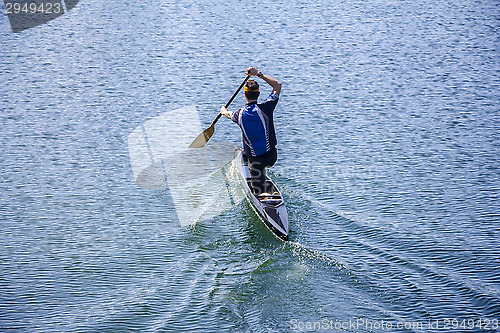 Image of Man rowing in a canoe 