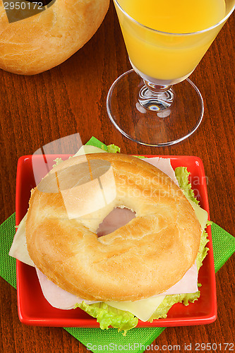 Image of Bagel with ham, cheese and lettuce and orange juice