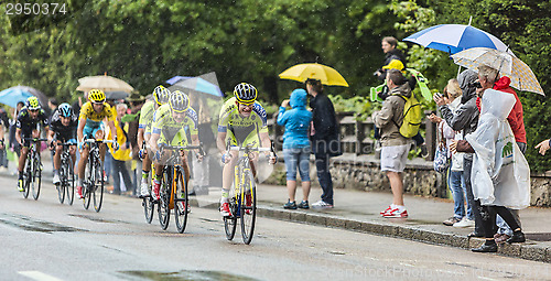 Image of Group of Cyclists Riding in the Rain