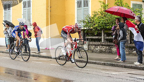 Image of Two Cyclists Riding in the Rain