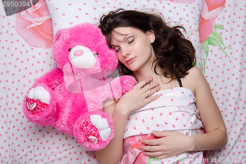 Image of Girl sleeping with teddy bear