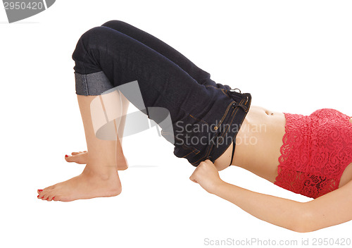 Image of Woman putting pants on.