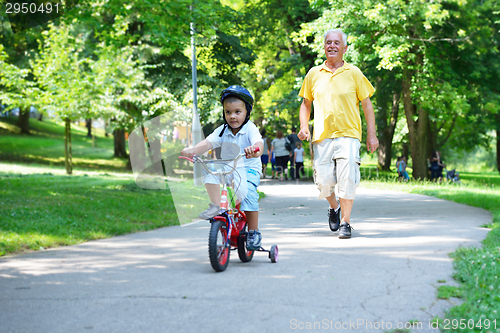 Image of happy grandfather and child in park