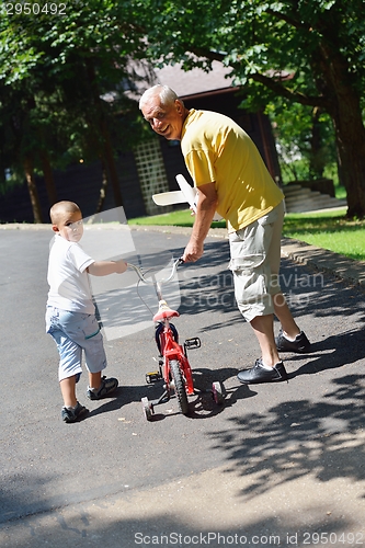 Image of happy grandfather and child in park