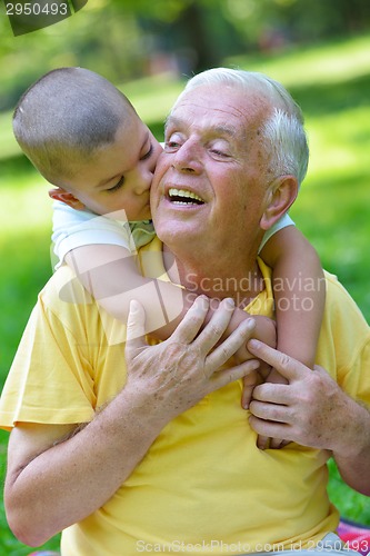 Image of happy grandfather and child in park