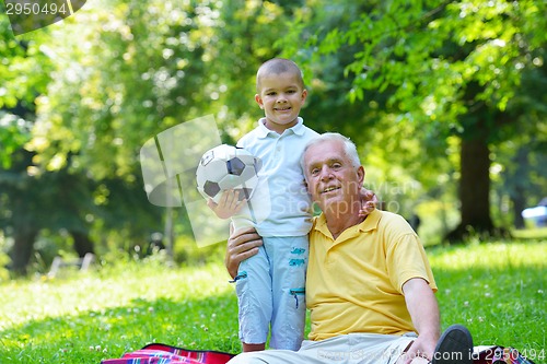 Image of happy grandfather and child in park