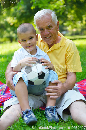 Image of happy grandfather and child in park