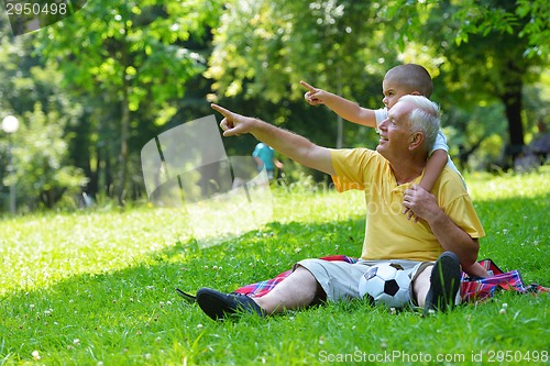 Image of happy grandfather and child in park