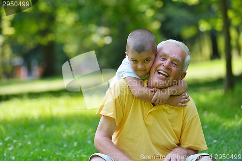 Image of happy grandfather and child in park