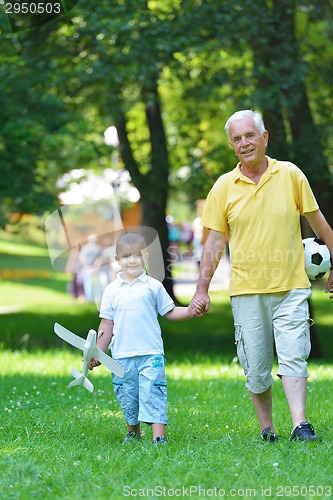 Image of happy grandfather and child in park