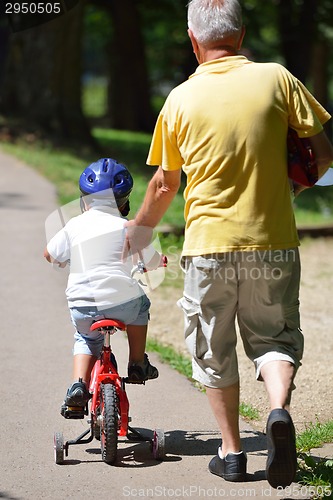 Image of happy grandfather and child in park