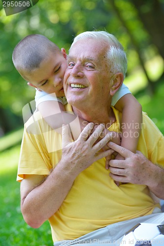 Image of happy grandfather and child in park