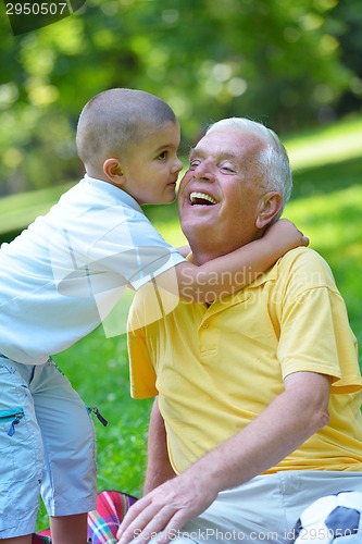 Image of happy grandfather and child in park