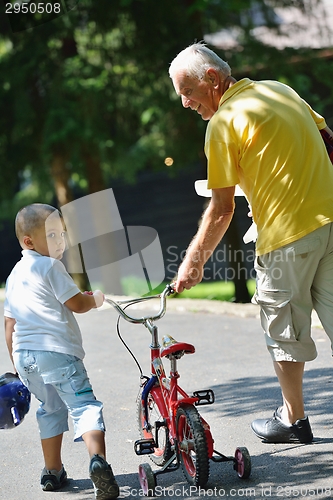 Image of happy grandfather and child in park