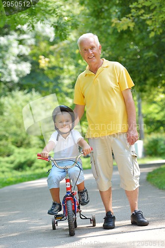 Image of happy grandfather and child in park