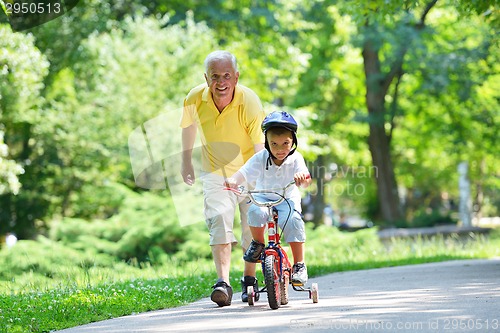 Image of happy grandfather and child in park