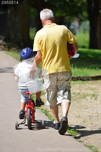 Image of happy grandfather and child in park
