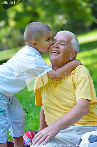 Image of happy grandfather and child in park