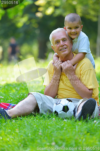 Image of happy grandfather and child in park