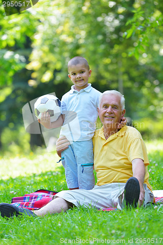 Image of happy grandfather and child in park