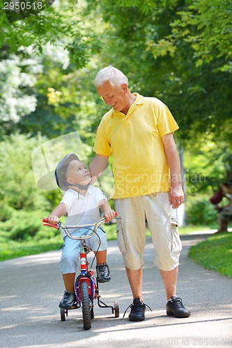 Image of happy grandfather and child in park