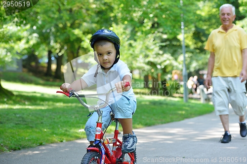 Image of happy grandfather and child in park