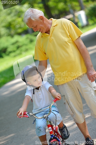 Image of happy grandfather and child in park