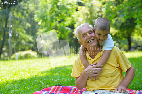 Image of happy grandfather and child in park