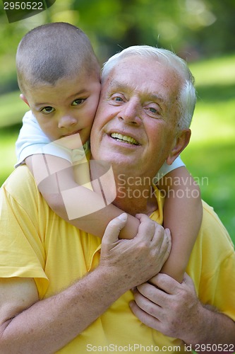 Image of happy grandfather and child in park